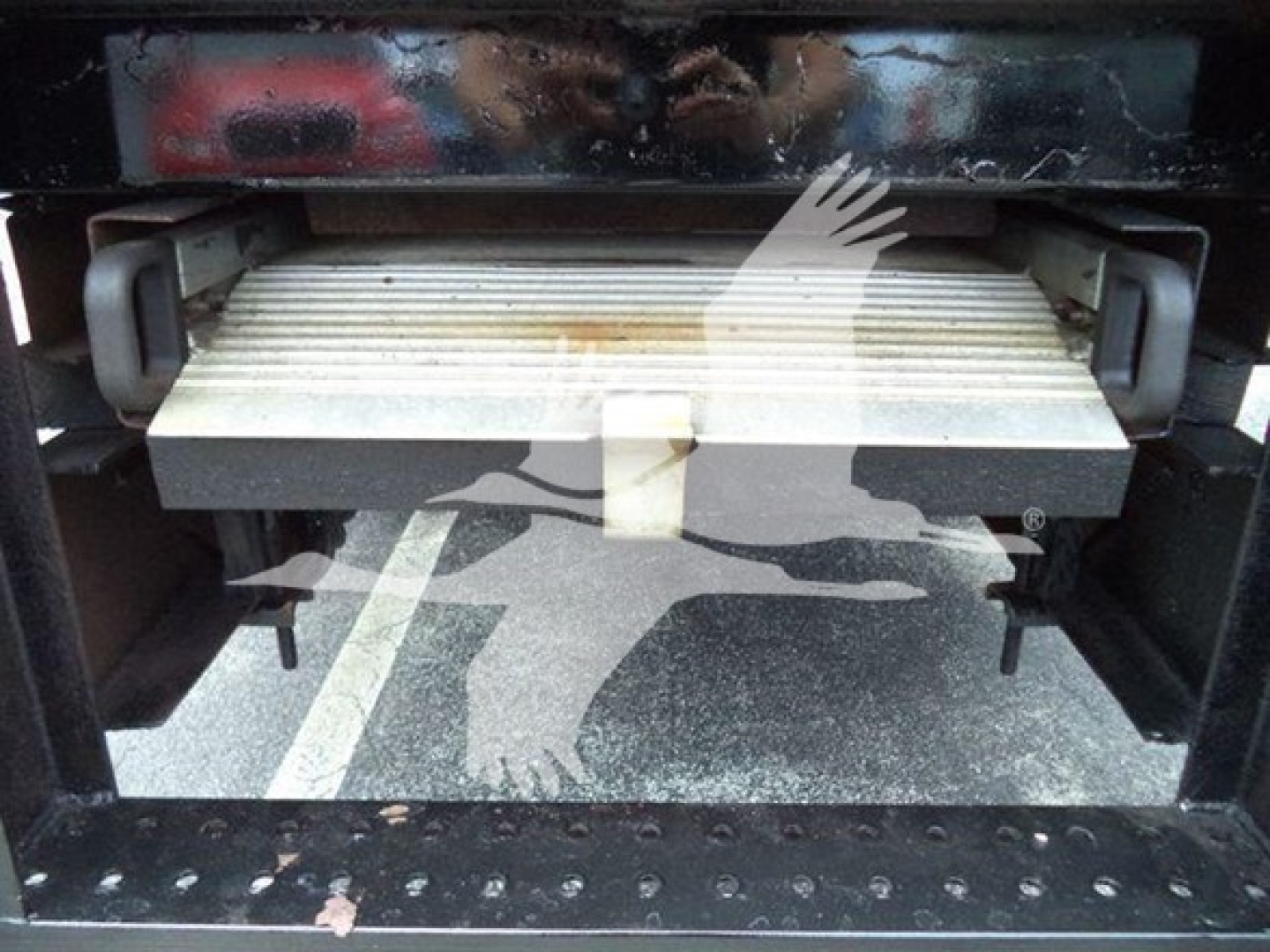 Hino 195 refrigerated truck tail area showing manual lift gate platform partially extended with metal slats and side handles.