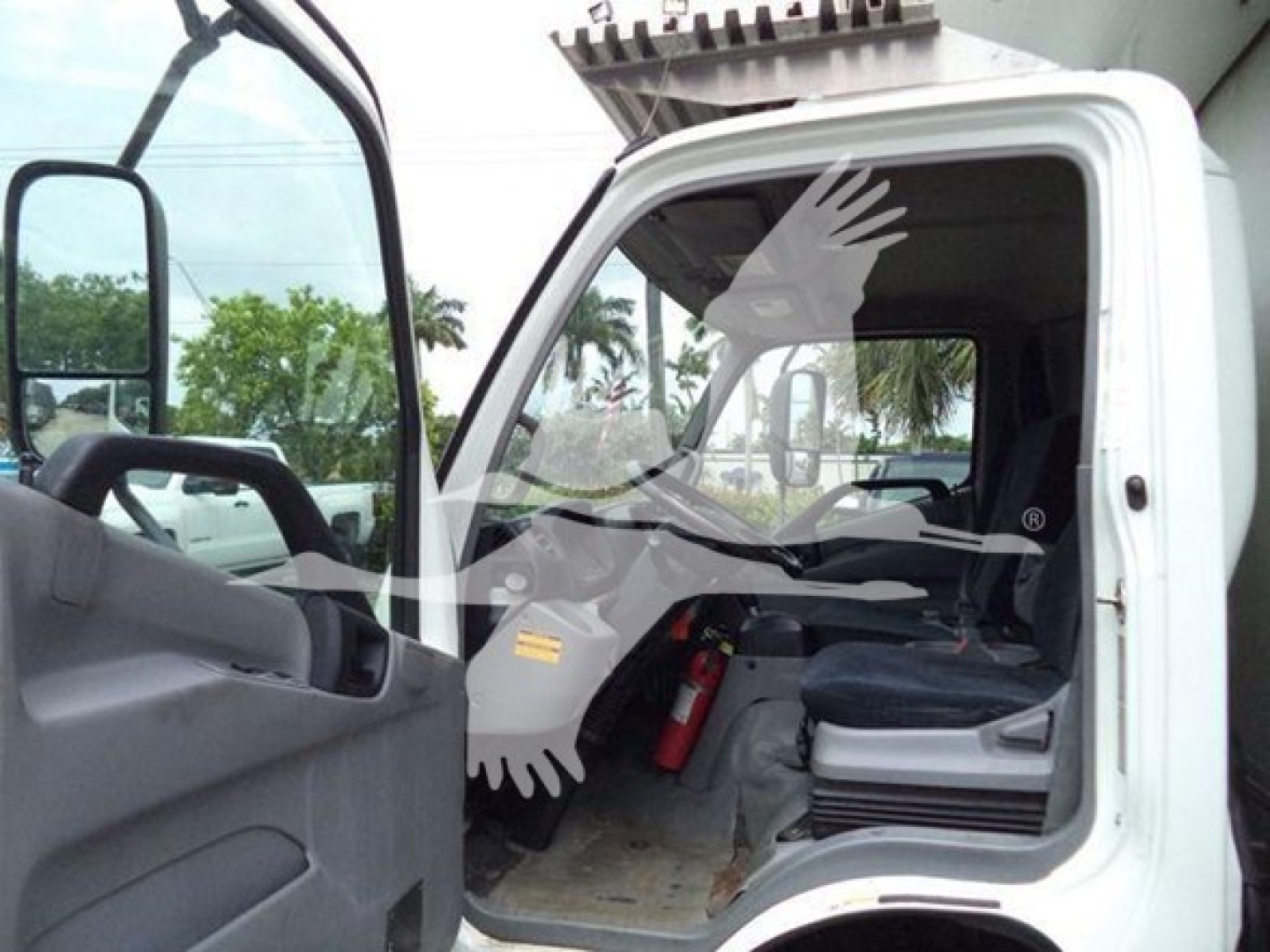Cab interior of a 2020 Hino 195 refrigerated truck with open driver door showing seat, dashboard, and floor; visible VIN and stock context not on the image but listing text nearby.