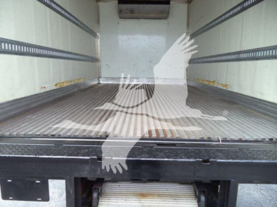 Truck cargo area of a 2020 Hino 195 refrigerated truck showing empty metal floor and side rails.