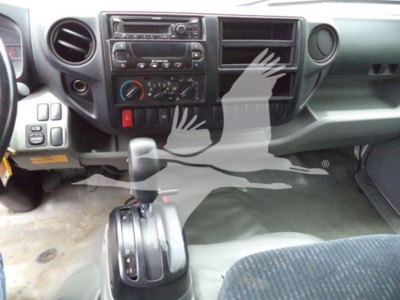 Dashboard and gear selector of a 2020 Hino 195 cab showing center console controls and climate dials.