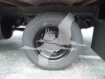 Hino 195 refrigeration truck rear wheel and undercarriage showing Goodyear tire and suspension components.