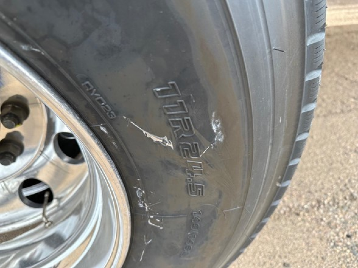 Mac Western light weight aluminum end dump trailer tire and wheel with tire brand and model markings visible.