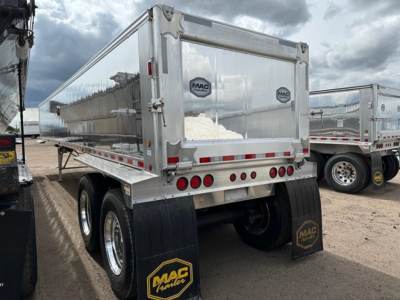 Mac Western light weight aluminum end dump trailer showing rear end with MAC trailer logos and dual axles with black mud flaps.