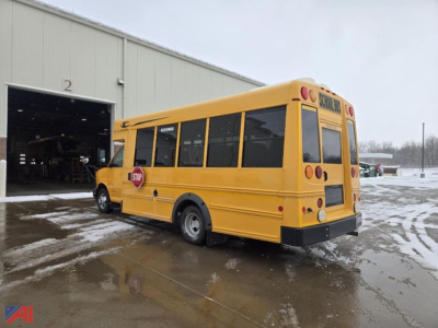 Chevrolet Express G4500 mini school bus in service bay, yellow body, rear and side view showing stop sign and school bus markings