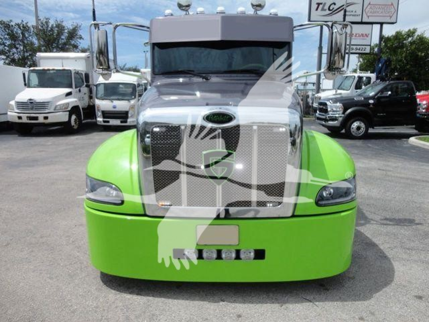 Peterbilt 337 front view showing bright green bumper and chrome grille with Peterbilt emblem and headlights.
