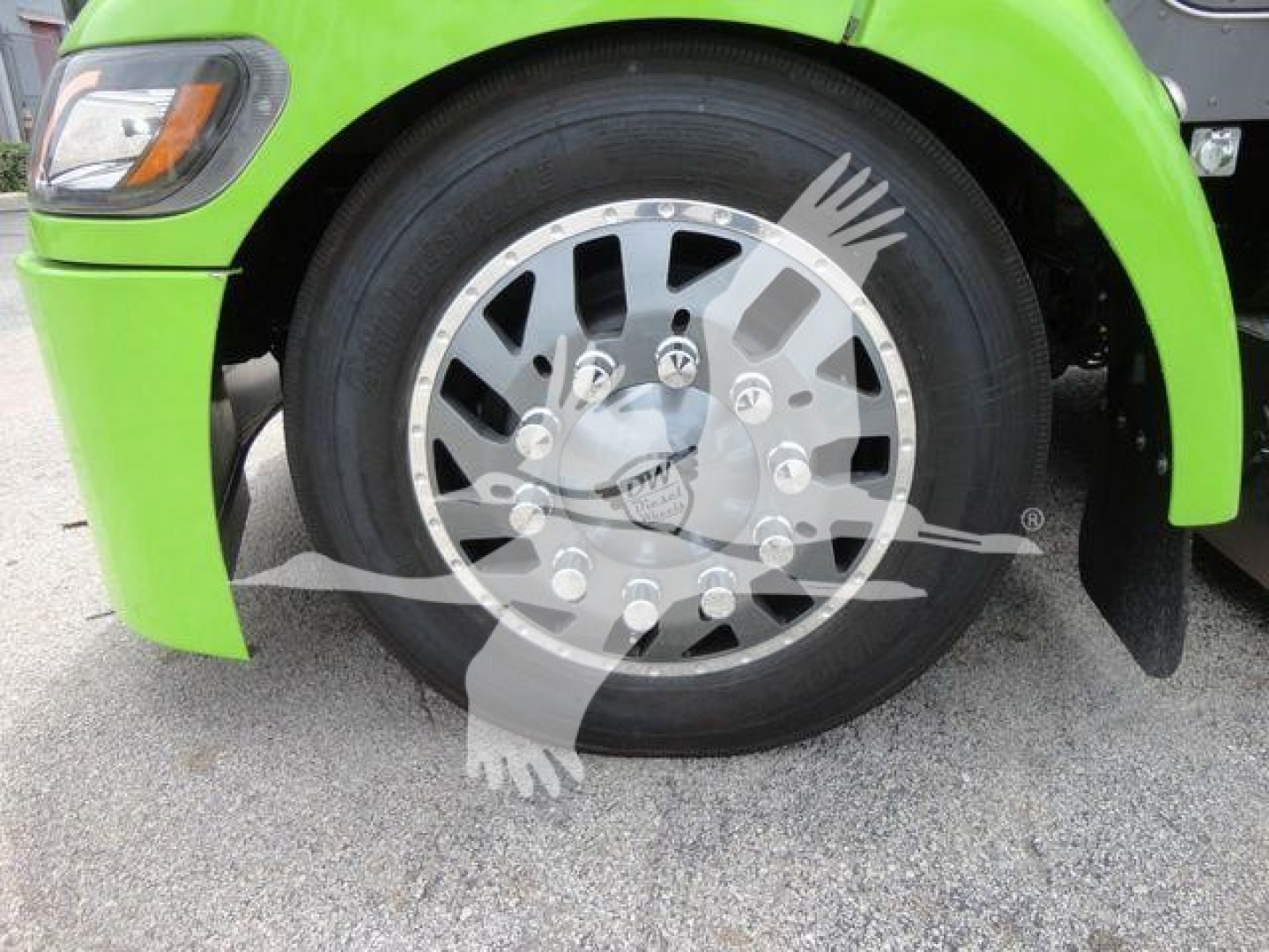 Peterbilt 337 truck front wheel and fender in lime green color, large chrome wheel with hubcap.