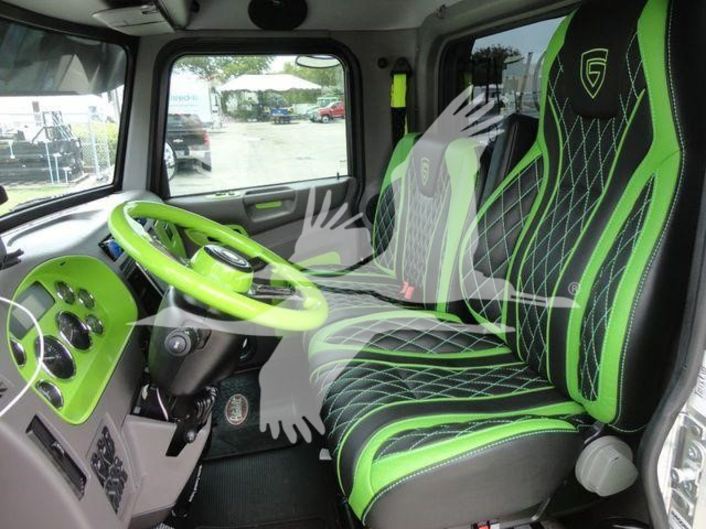 Truck cab interior showing lime green steering wheel and seats with black-and-green stitched pattern in a Peterbilt truck.