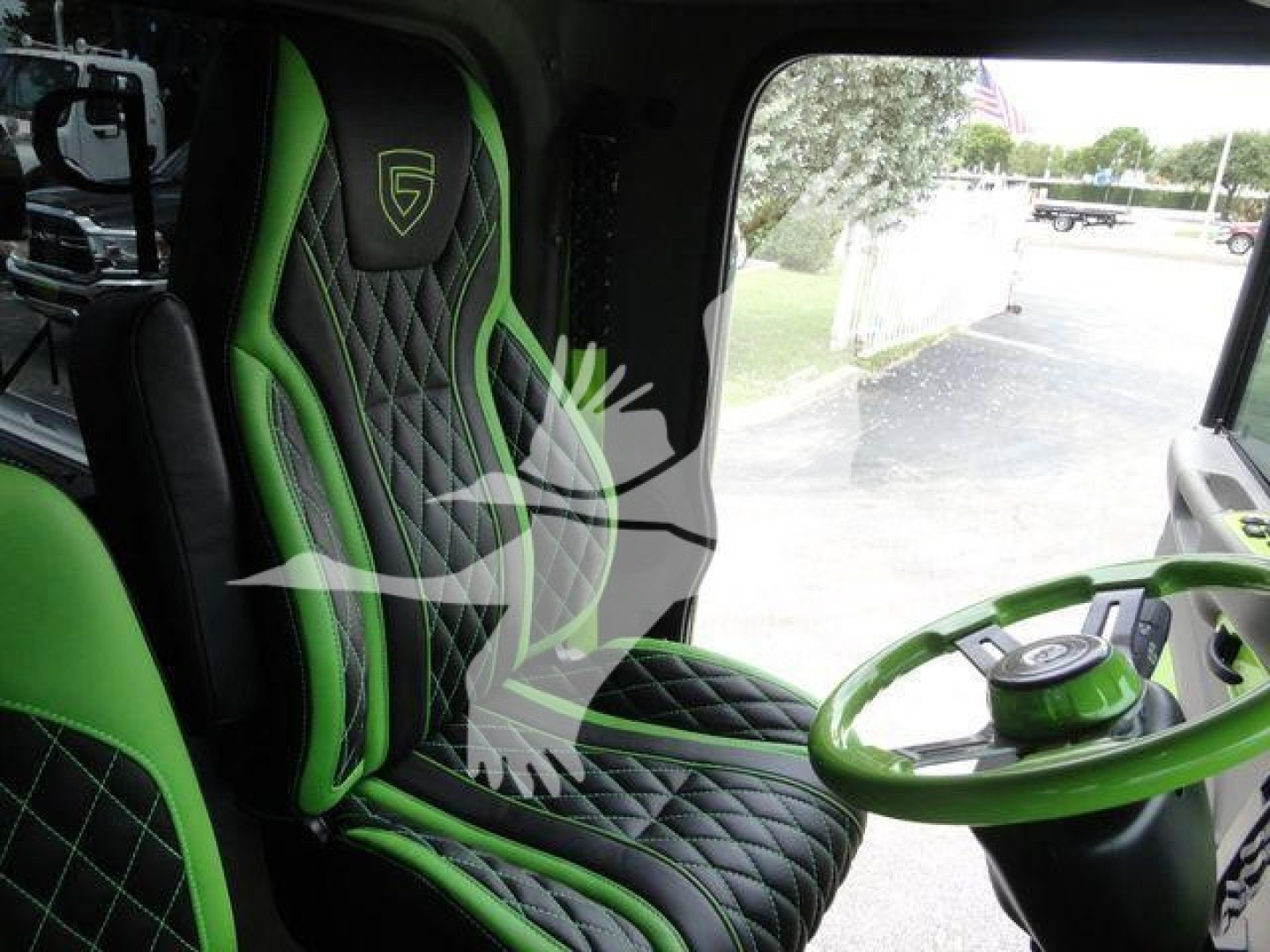 Peterbilt 337 cab interior showing green and black diamond-stitched seats and green steering wheel.