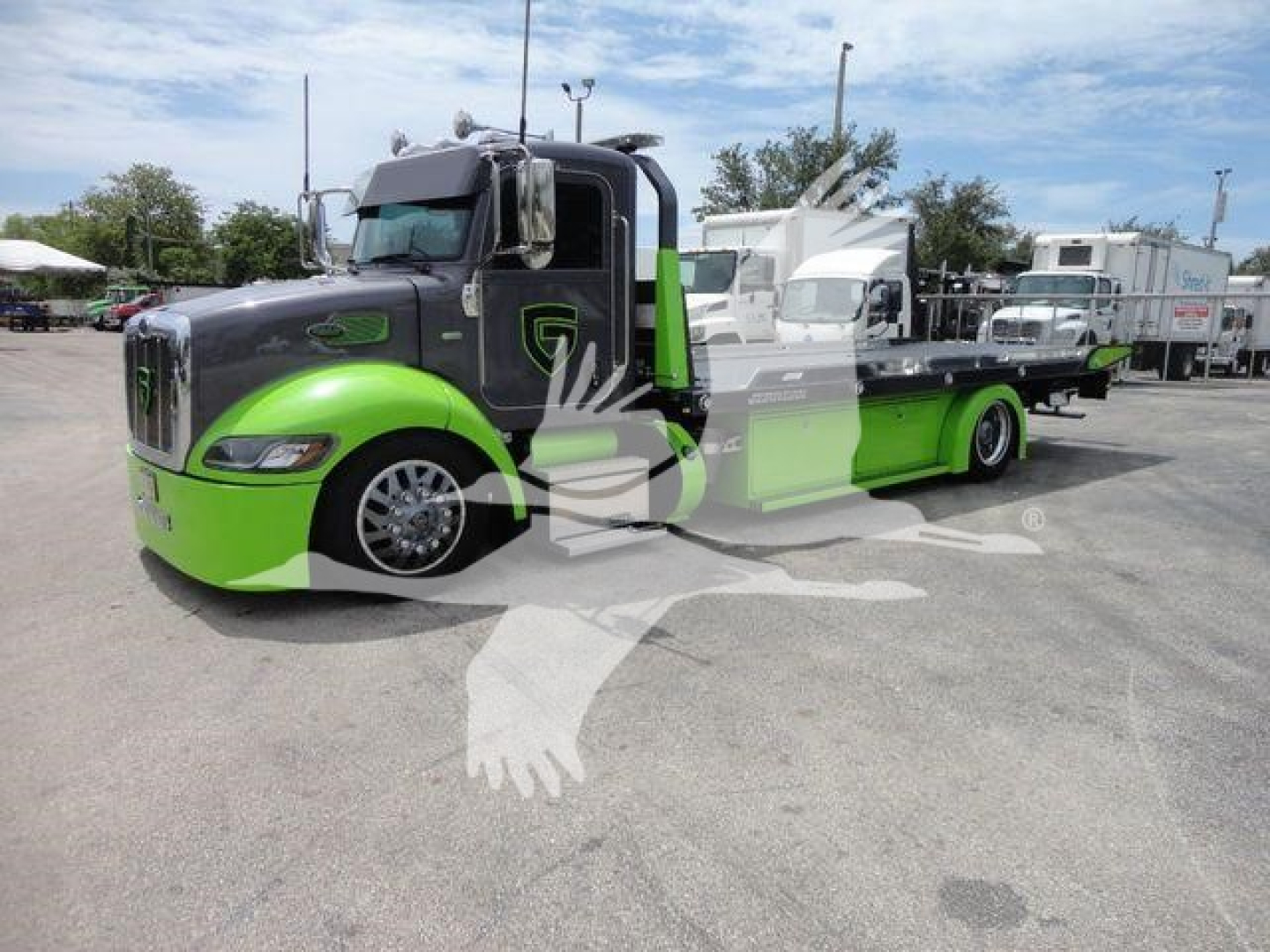 Peterbilt 337 truck in-used condition with green and black paint, rollback bed, side view showing green fenders and logo