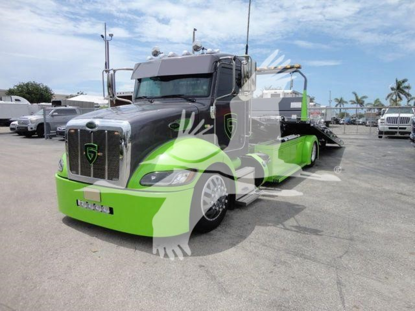 2020 Peterbilt 337 rollback tractor pictured, black and bright green color scheme, front grille badge visible, side view shows frame with lift equipment in a dealership lot.