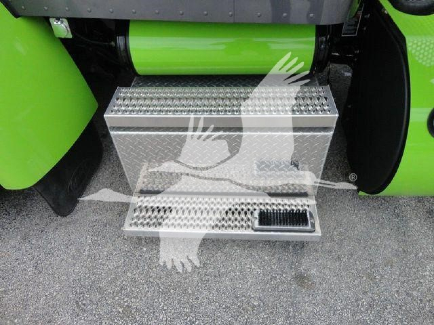 Step/side access step showing diamond plate metal step with integrated door area on a green Peterbilt truck.