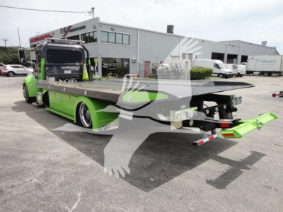 Truck bed tow rollback body of a green 2020 Peterbilt 337 tractor/rollback with flatbed and towing apparatus visible.
