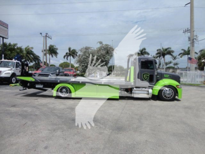 Peterbilt 337 rollback truck in bright green livery with flatbed, side view showing cab and engine bay.