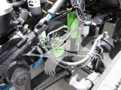 Peterbilt 337 engine bay/under-hood area with hoses, reservoirs, and wiring harnesses visible