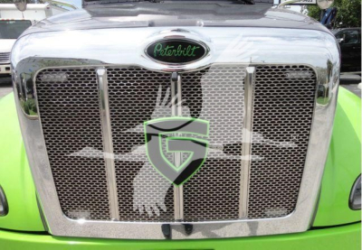 Peterbilt chrome grille with oval Peterbilt emblem on top center; bright green truck hood visible around grille.