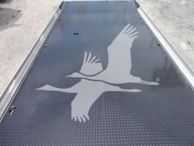 Peterbilt 337 rollback truck bed with diamond plate and a large bird decal in white.