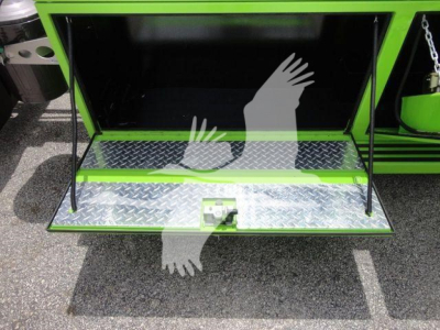 Peterbilt 337 rollback truck with open diamond plate storage compartment showing interior step and latch.