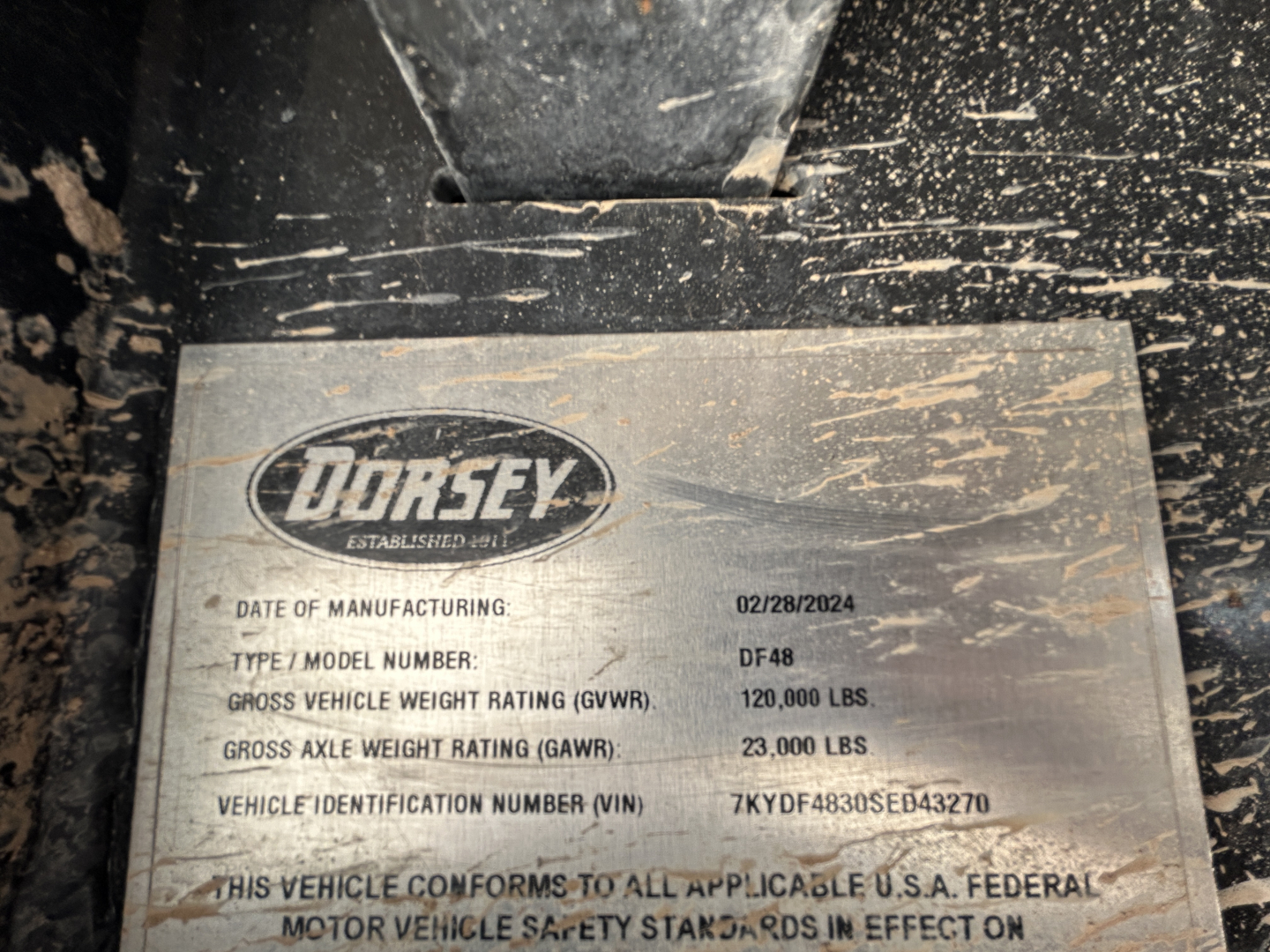 Dorsey DF48 60 Ton trailer VIN plate showing manufacturing date 02/28/2024, model DF48, GVWR 120,000 lbs, GAWR 23,000 lbs, VIN 7KYDF4830SED43270.