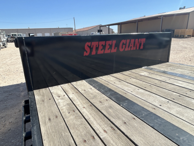 Trailer bed with Steel Giant branding on the side panel showing a 60-ton drop deck trailer with wooden deck planks.