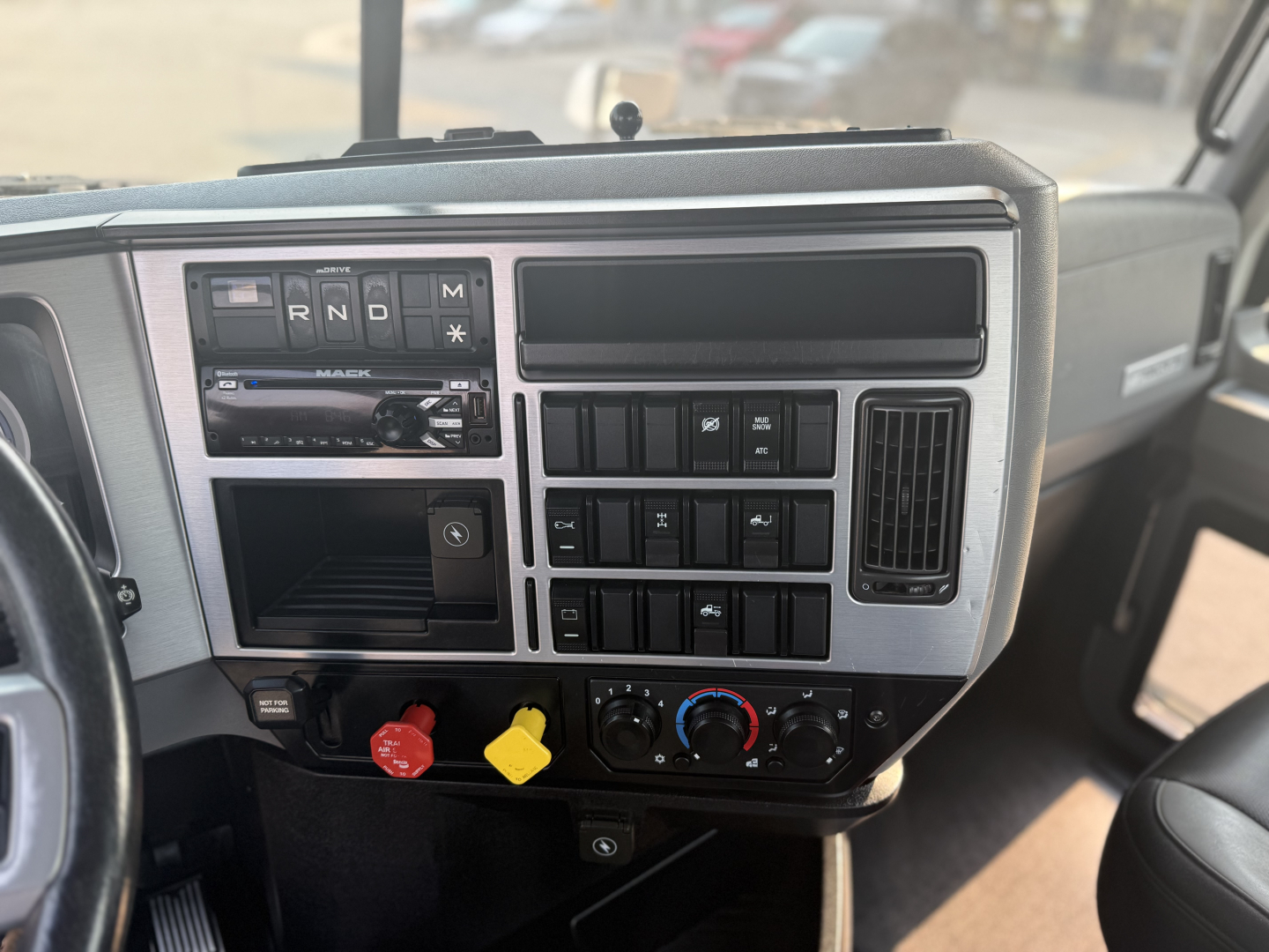 Dashboard view of a 2020 Mack Anthem truck interior showing gear selector panel, radio, climate controls, and ignition area.
