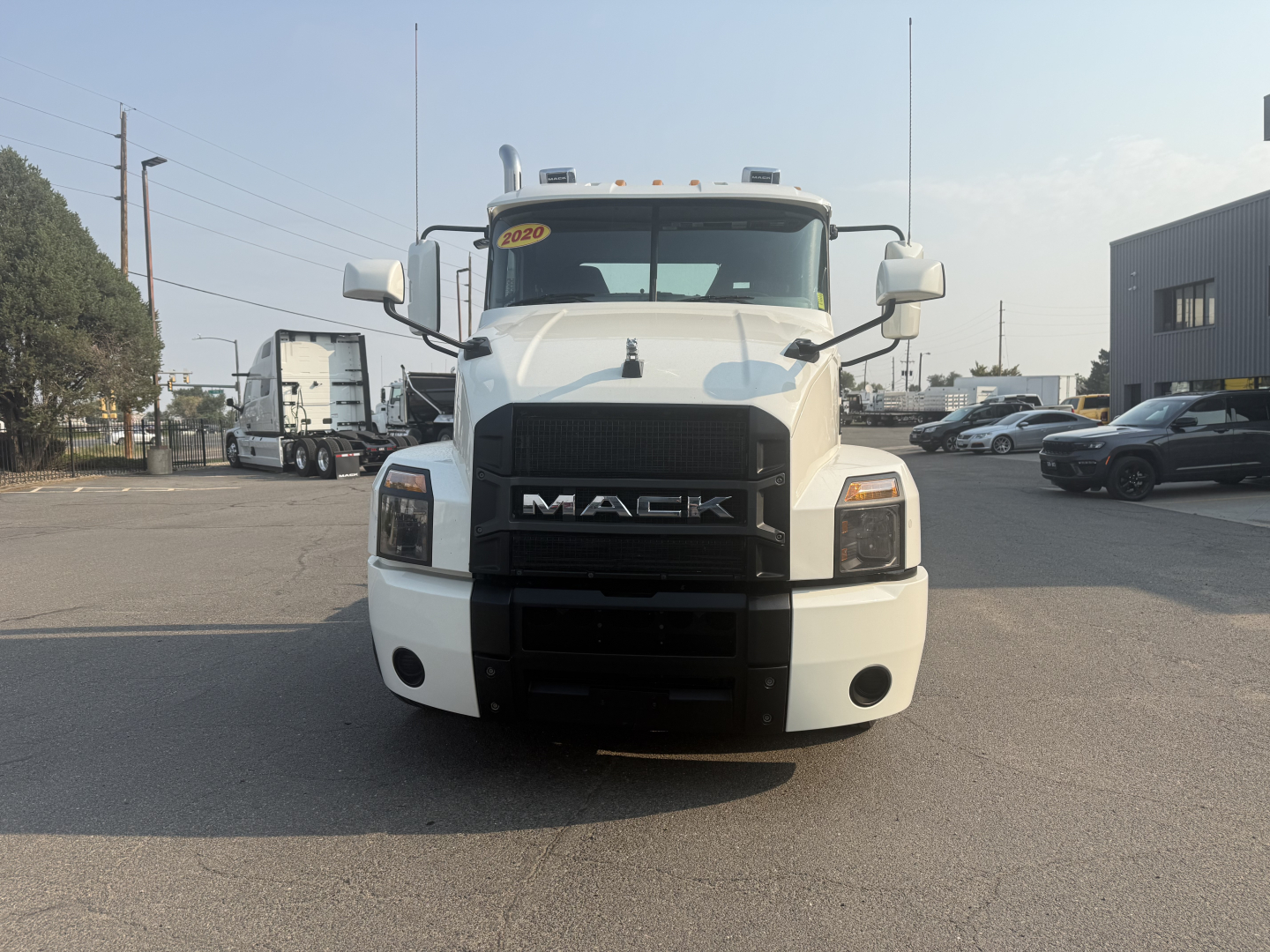 Mack Anthem 2020 conventional daycab truck front view showing Mack grille and bumper with white paint.