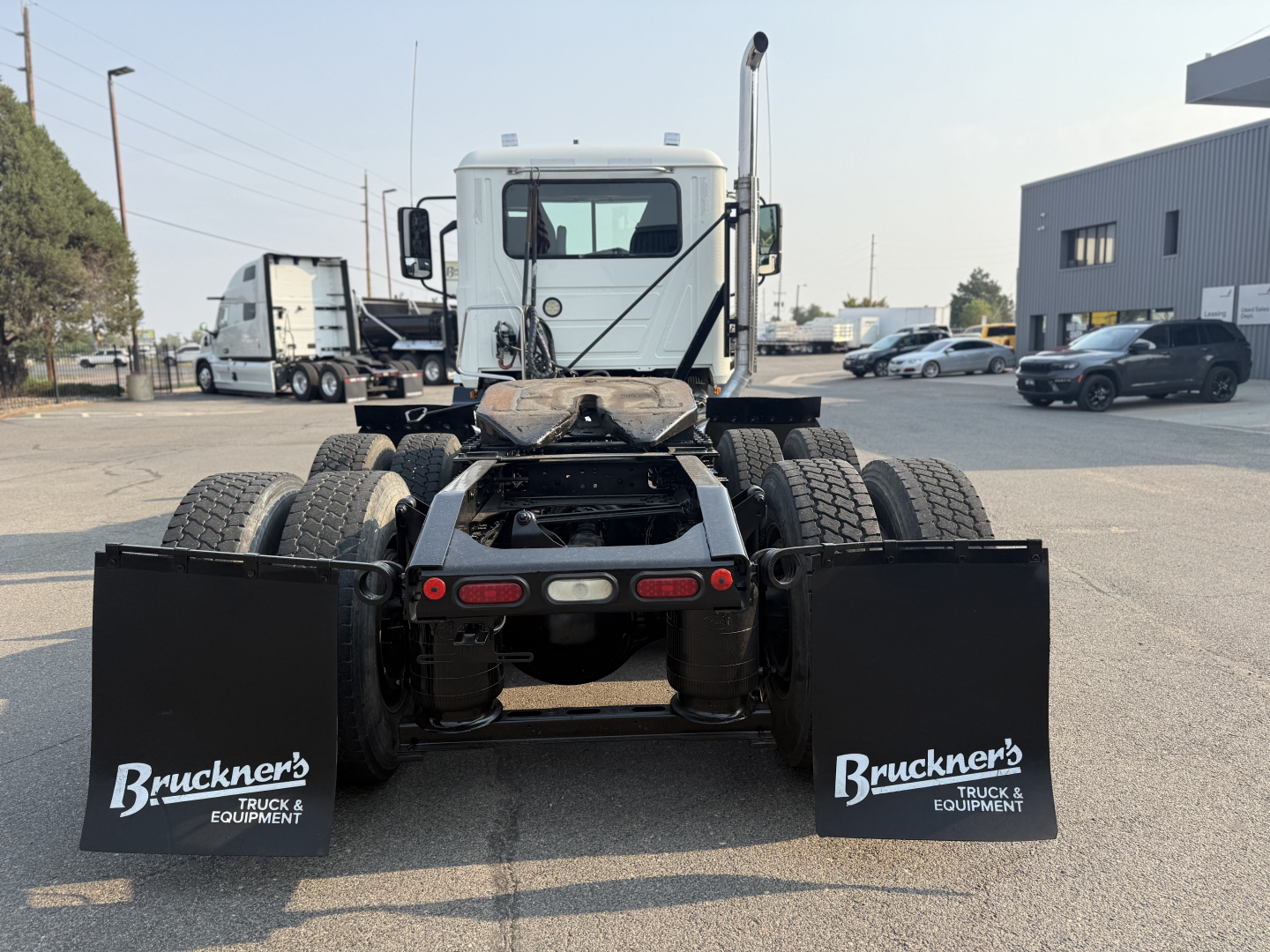 Truck rear view showing fifth wheel chassis and dual rear axles with mud flaps labeled 'Bruckner's Truck & Equipment'