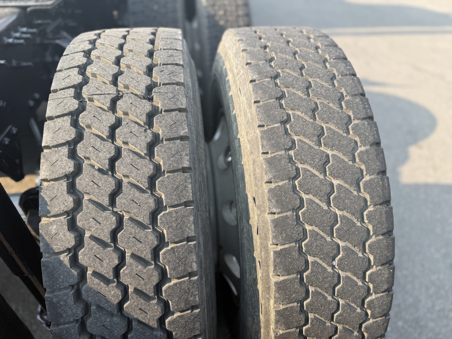 Dual rear tires on a Mack ANTHEM truck, treads visible with blocky pattern.
