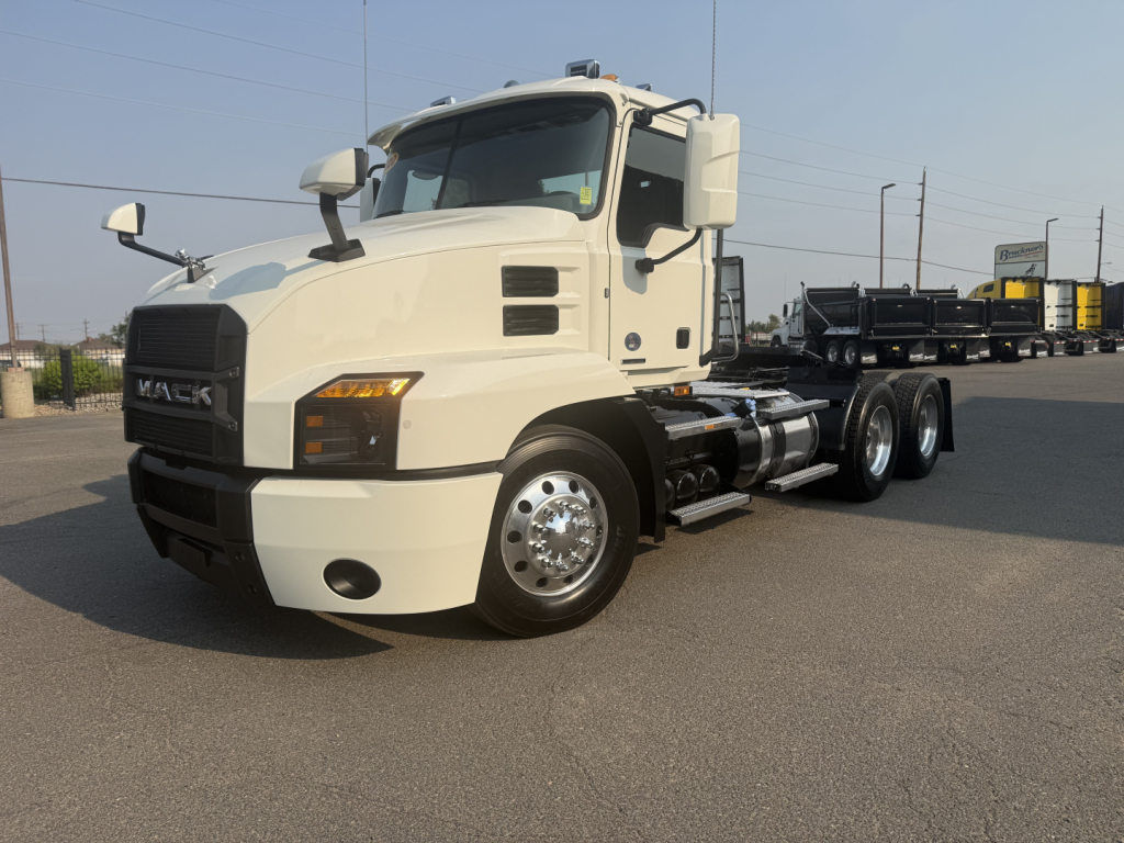 Mack Anthem daycab truck in light color, front-left view showing cab, mirrors, and dual rear axles.