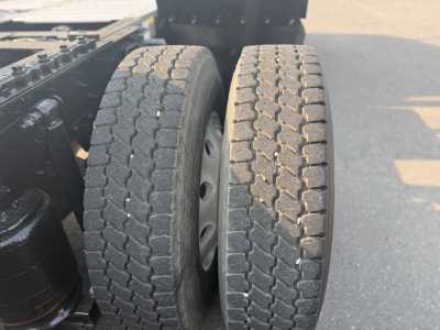 Truck rear tires and chassis of a 2020 Mack Anthem Conventional Daycab showing dual tires and rear suspension components.