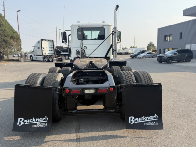 Truck rear view showing fifth wheel chassis and dual rear axles with mud flaps labeled 'Bruckner's Truck & Equipment'