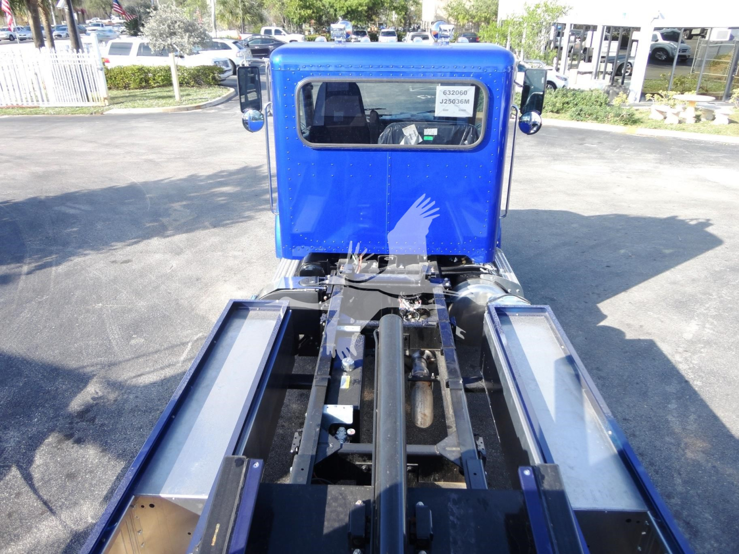 Peterbilt 337 chassis with blue cab, rear view showing rollback tractor frame and wheel wells.
