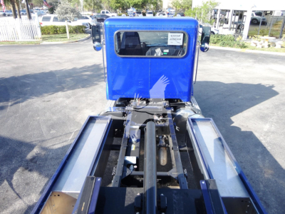 Peterbilt 337 chassis with blue cab, rear view showing rollback tractor frame and wheel wells.