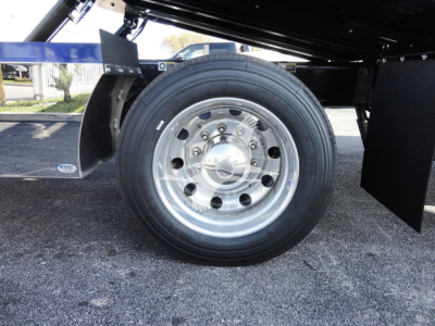 Peterbilt 337 truck wheel and front fender area showing polished wheel, tire, and undercarriage components.
