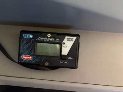 Kenworth T680 dash area showing a GEW power inverter display panel labeled Tundra and fault indicator.
