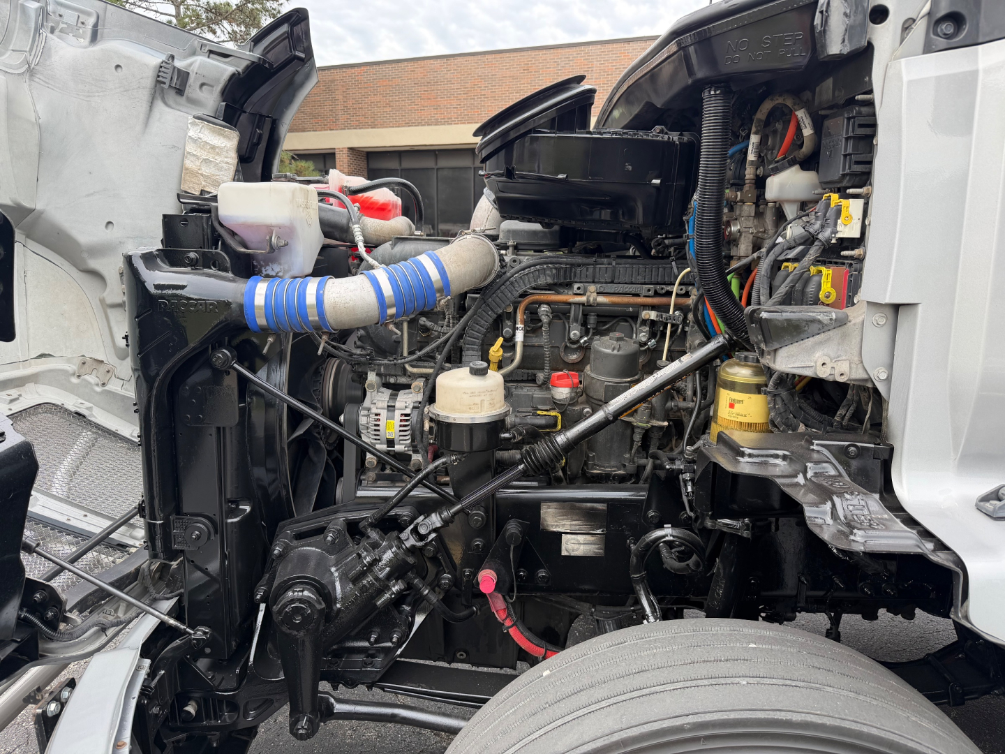Kenworth T680 engine bay showing diesel engine and surrounding components.