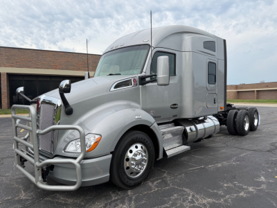 Kenworth T680 highway-tractor side view showing sleeper cab, chrome wheels, front grille guard, dual rear axles, and chrome fuel tanks.