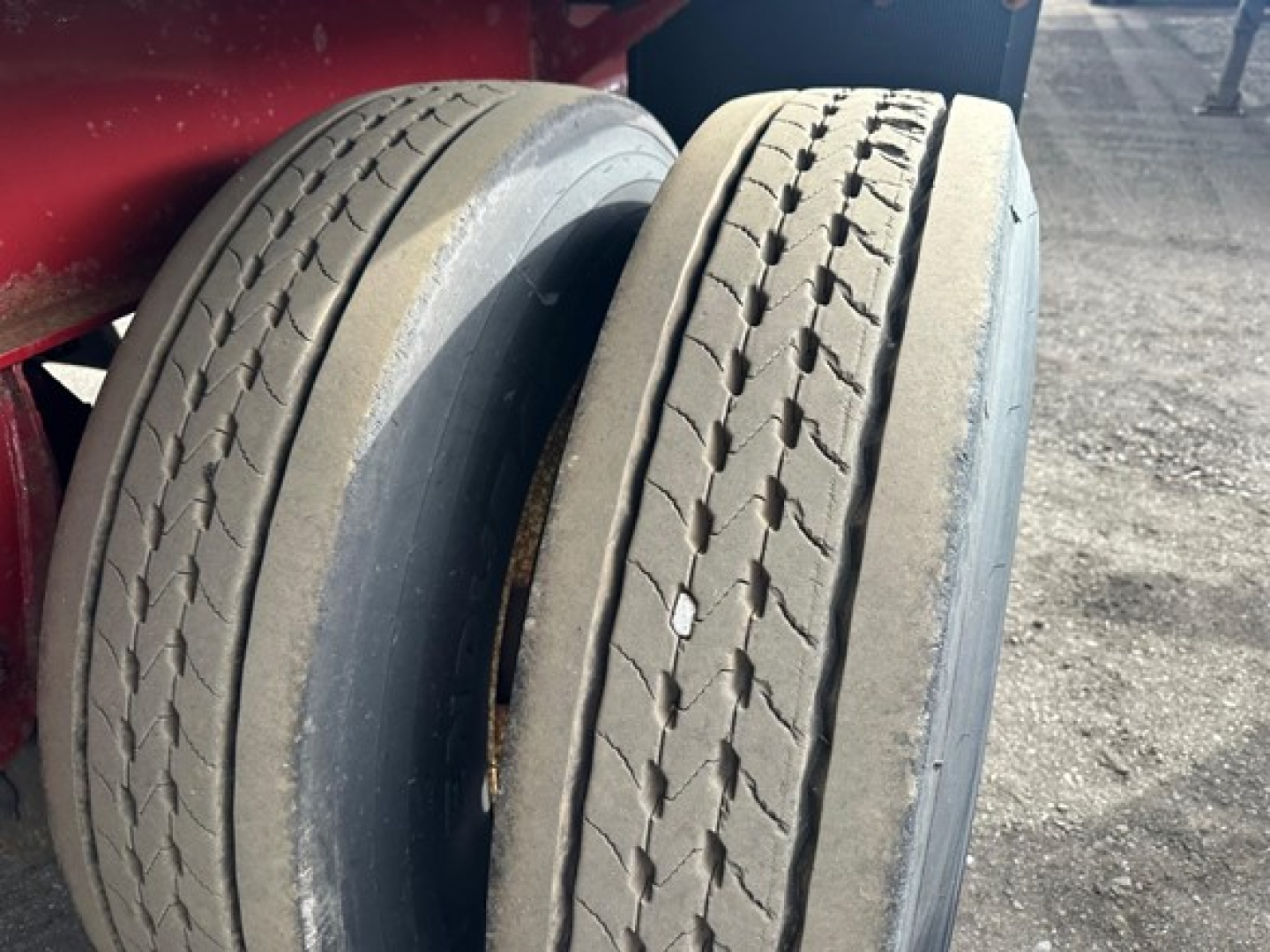Textricated view of trailer tires mounted on Fontaine INFINITY flatbed trailer. Dual tires with tread and sidewall details visible.