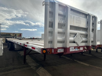 Flatbed trailer rear and side view showing Fontaine Infinity branding, back diamond plate, taillights, and license/stock number area on red ledger.