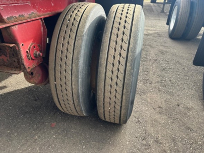 Fontaine INFINITY trailer dual rear wheels showing worn tires and red hitch area.
