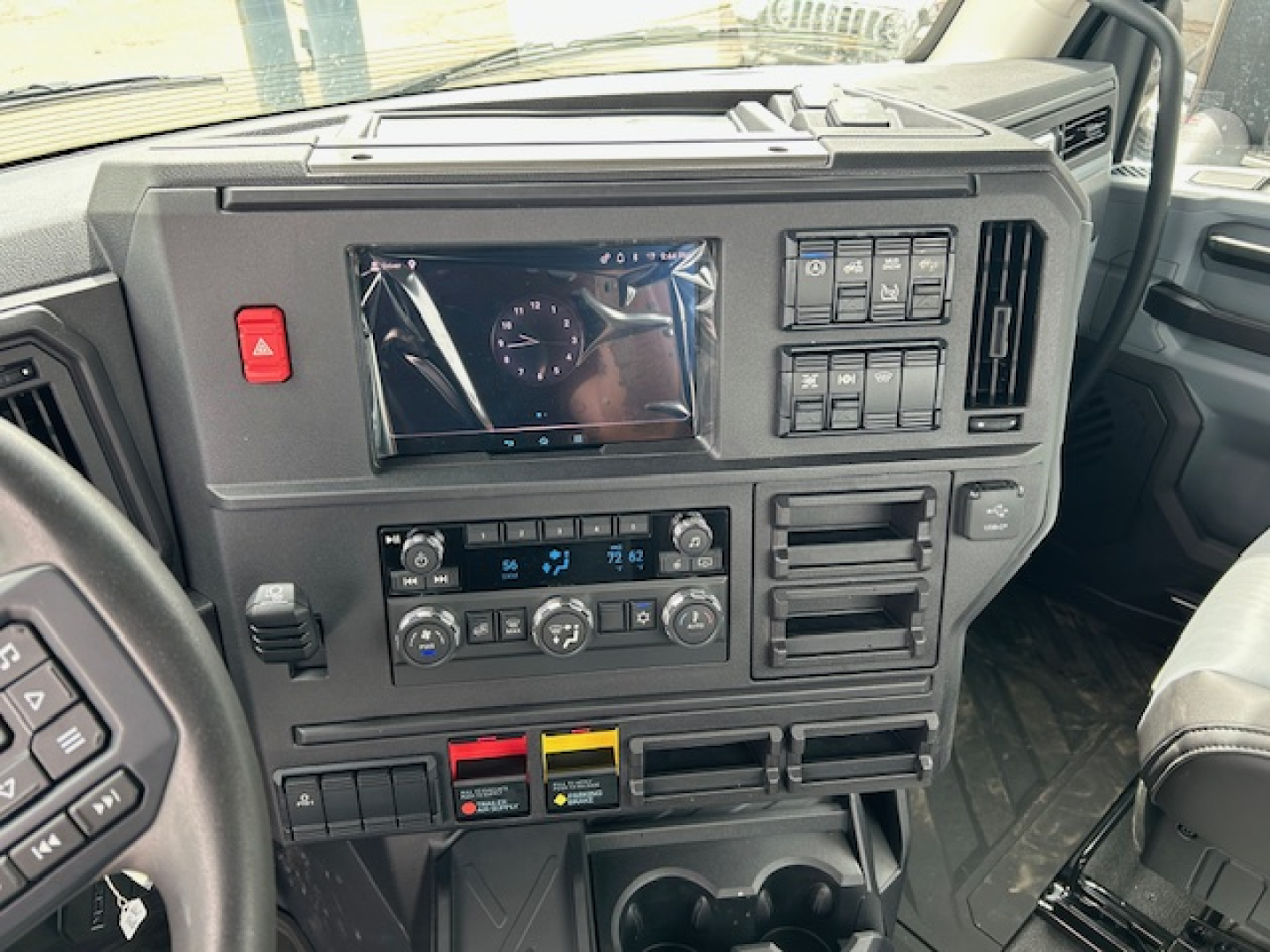 Mack AN64T dash and center console showing touchscreen display and control panels.