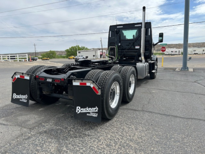 2027 Mack AN64T tractor rear view showing dual rear axles, fifth wheel area, mud flaps with Bruckner's logo, and bare chassis.