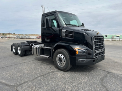 Mack AN64T conventional daycab truck in black, front three-quarter view showing cab and chassis with dual rear axles and MACk grille.