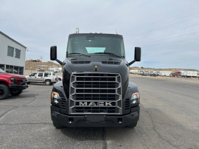 Front view of a black 2027 Mack AN64T conventional daycab truck showing bold front grille with MACK emblem and large bumper.