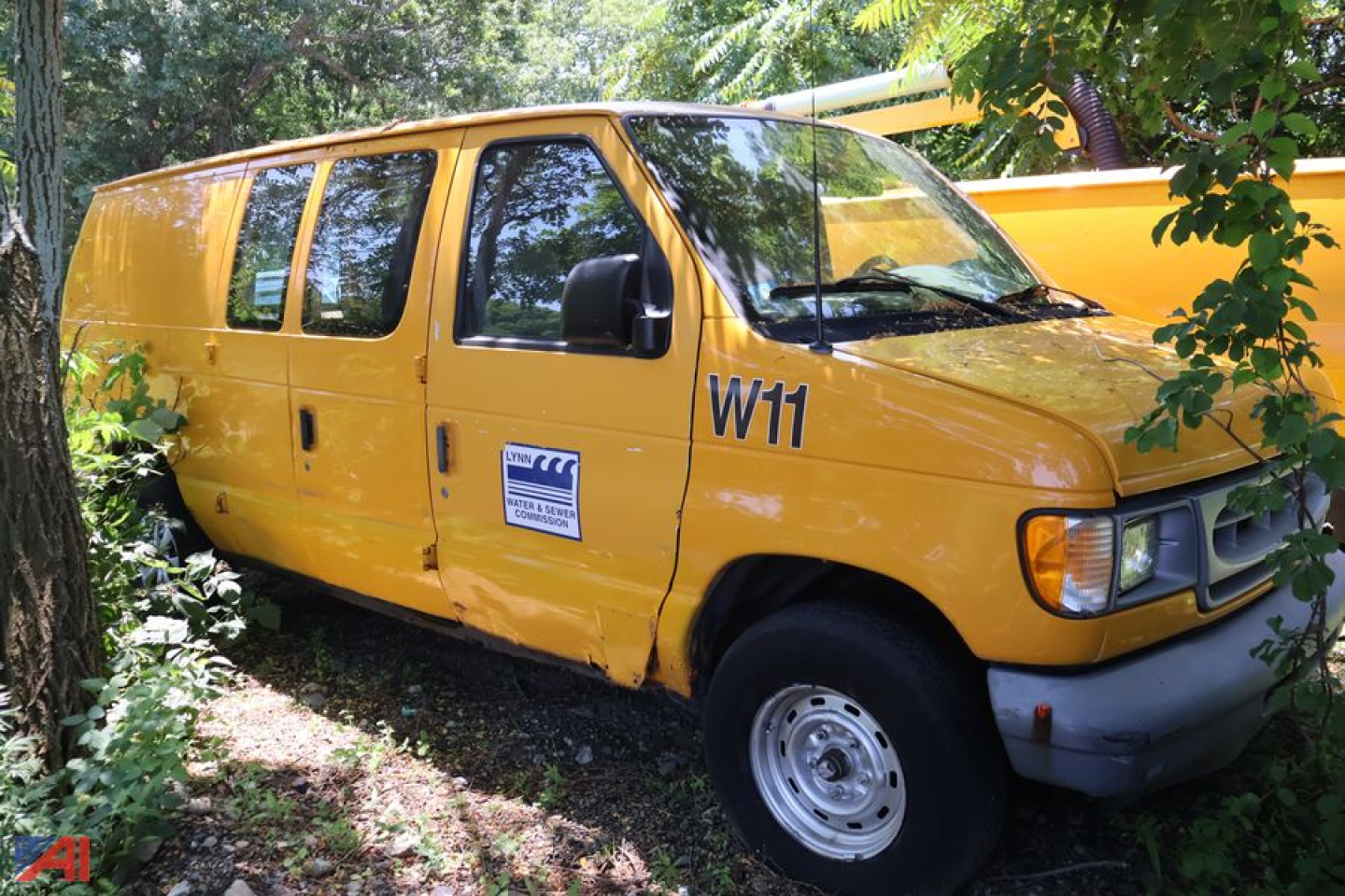 Ford E150 cargo van in-service showing W11 marking and a side sticker.