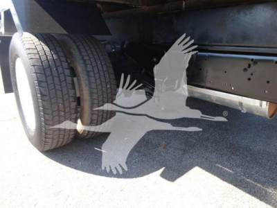 Ford E450 truck rear/underbody showing dual rear wheels and undercarriage components.