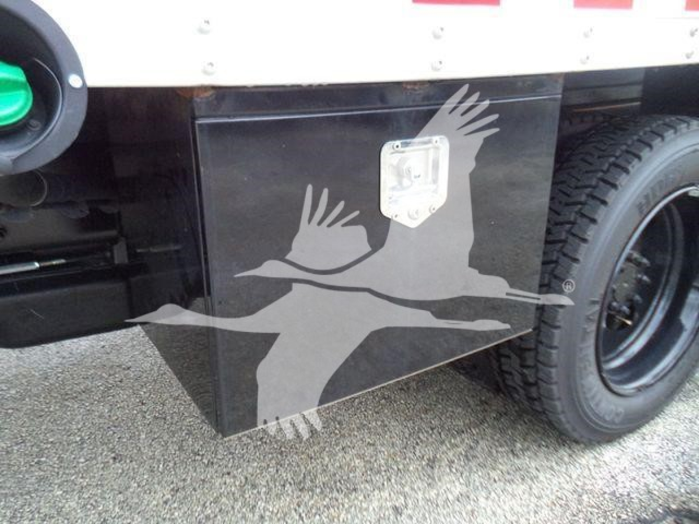 Trucks background showing toolbox with square handle and wheel; part of a 2023 Chevrolet Silverado 6500HD listing.