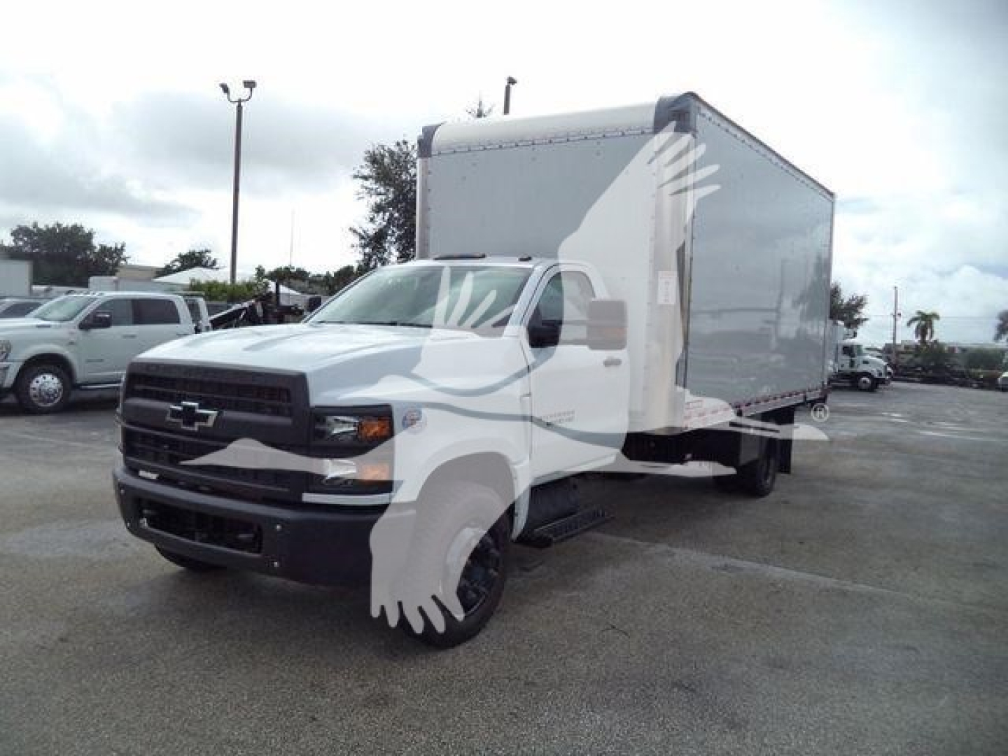 Chevrolet Silverado 6500HD box truck viewed from front-left in dealership lot.
