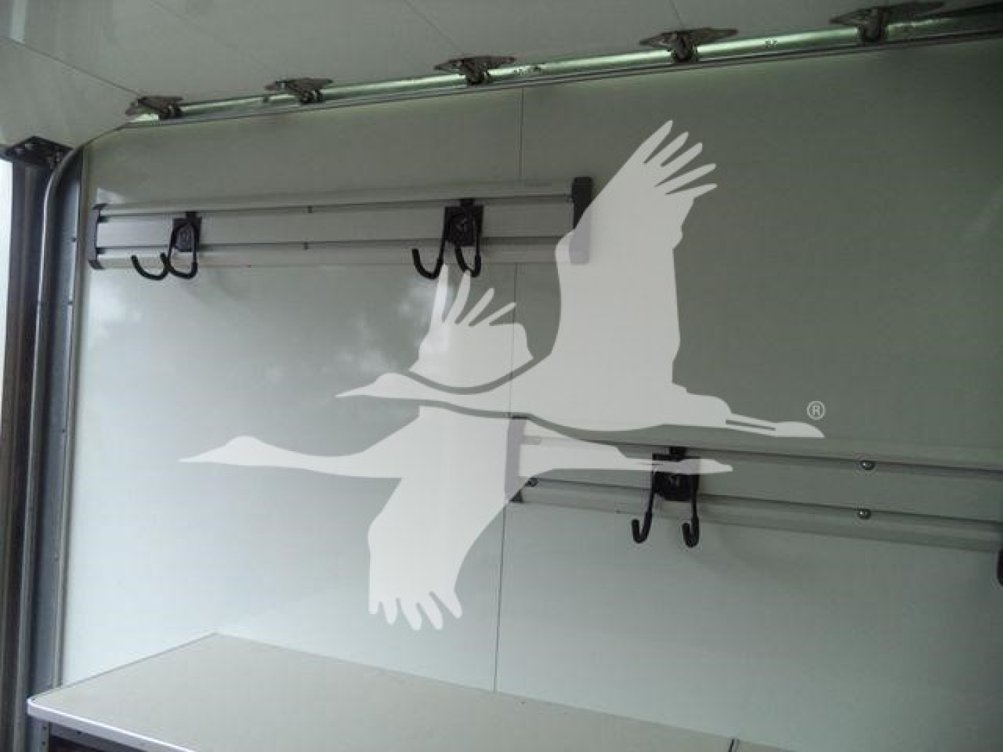 Box truck interior with metal side panels and hooks for securing cargo, Chevrolet Silverado 6500HD listed as new.