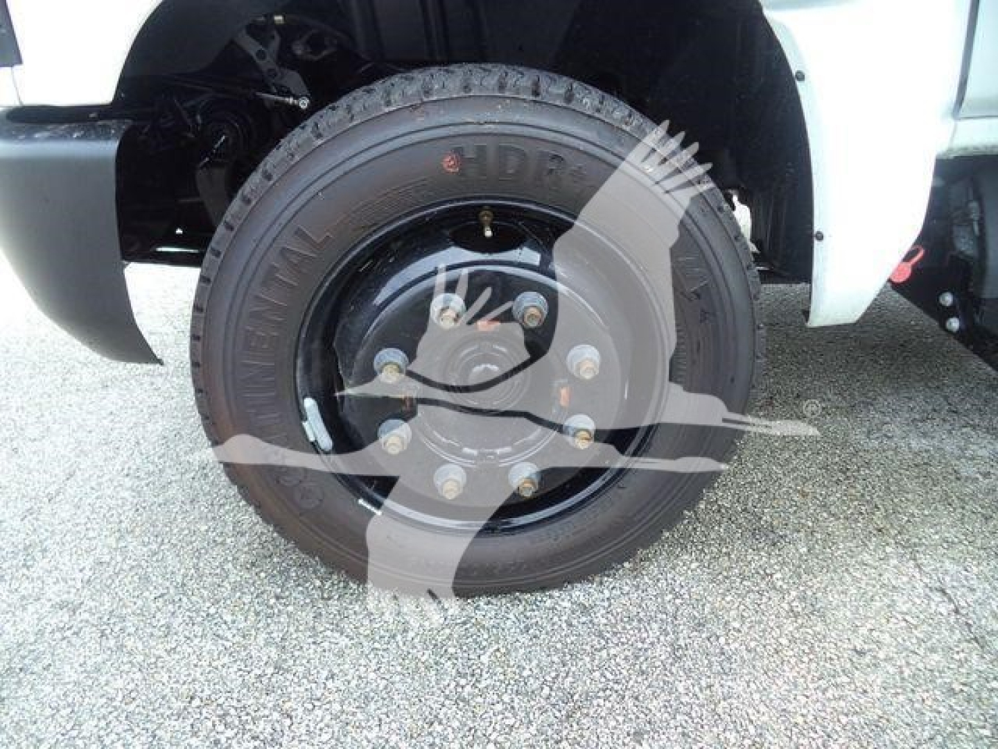 Front wheel of a 2023 Chevrolet Silverado 6500HD with tire and hub visible in the wheel well.