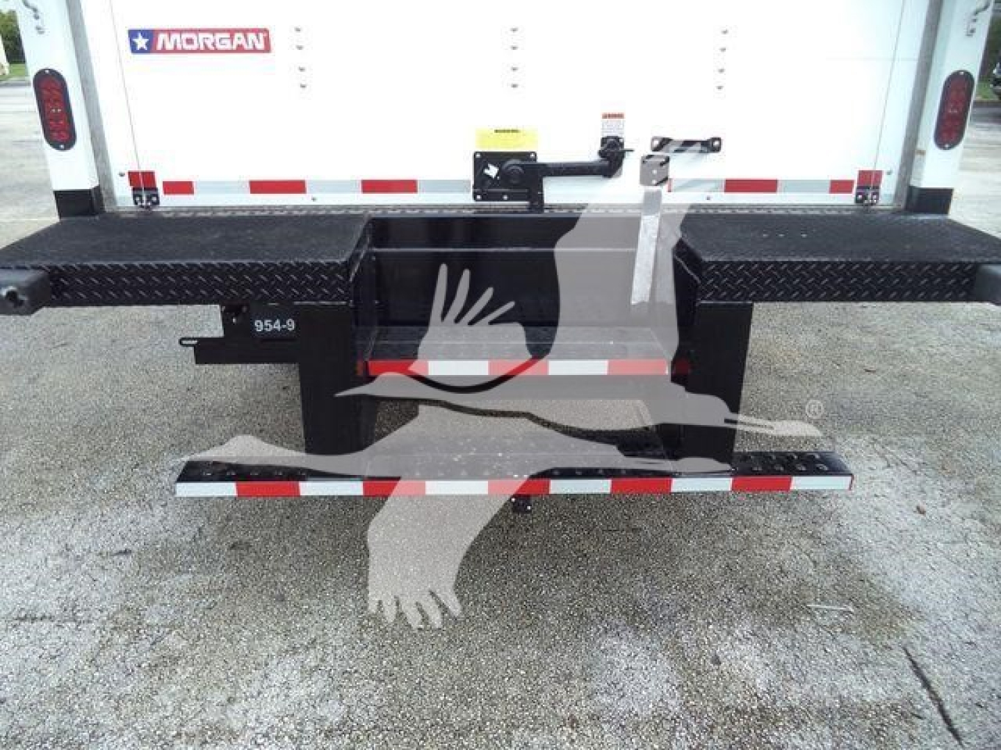 Rear view of a 2023 Chevrolet Silverado 6500HD box truck showing a dual black steel step/bumper with textured platforms and rear hitch, Morgan branding on the back door.